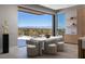 Open dining area with a patio view, modern furniture, and a neutral color palette at 505 Dragon Gate Ct, Henderson, NV 89012