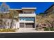 Modern home featuring a multi-car garage, xeriscaping, and desert-friendly landscaping at 505 Dragon Gate Ct, Henderson, NV 89012