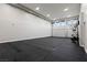 Spacious home garage featuring a dark rubber floor and open space for a home gym or workout area at 505 Dragon Gate Ct, Henderson, NV 89012