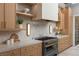 Close-up of the kitchen with stainless steel stove, marble countertops, and custom cabinetry at 505 Dragon Gate Ct, Henderson, NV 89012