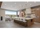 Open-concept kitchen and dining area featuring a large island and a wall of glass windows at 505 Dragon Gate Ct, Henderson, NV 89012