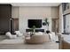 Well-lit living room featuring a fireplace, large flatscreen TV, modern furniture, and eye-catching decor at 505 Dragon Gate Ct, Henderson, NV 89012