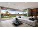 Large living room with a white sectional couch that opens up to the backyard swimming pool at 505 Dragon Gate Ct, Henderson, NV 89012