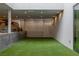 An outdoor recreation area designed with artificial turf, a projector, and a retaining wall at 505 Dragon Gate Ct, Henderson, NV 89012