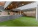 Private outdoor space with artificial turf, wood accents, lush greenery, and a modern design at 505 Dragon Gate Ct, Henderson, NV 89012