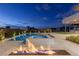 Luxurious pool area features a modern pool, hot tub, and fire pit, creating a stunning and inviting outdoor space at 505 Dragon Gate Ct, Henderson, NV 89012