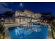 Night view of a modern home with a sparkling pool and manicured backyard, perfect for luxury living at 505 Dragon Gate Ct, Henderson, NV 89012