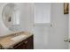 Powder room featuring a modern oval mirror and stone countertop at 5081 Pine Mountain Ave, Las Vegas, NV 89139