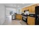 Functional kitchen with stainless steel appliances, wood cabinets, and neutral tile floors at 5081 Pine Mountain Ave, Las Vegas, NV 89139