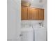 Convenient laundry room with washer, dryer, and storage cabinets for efficient organization and functionality at 5081 Pine Mountain Ave, Las Vegas, NV 89139