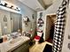 A well-lit bathroom features a vanity, mirror, and stylish shower curtain at 5225 W Reno Ave # 219, Las Vegas, NV 89118