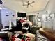 Bedroom with ceiling fan, TV, and a comfortable bed offering a relaxing private space at 5225 W Reno Ave # 219, Las Vegas, NV 89118