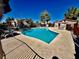Community pool with ample seating, and lush landscaping against a bright blue sky at 5225 W Reno Ave # 219, Las Vegas, NV 89118