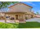Home's backyard with covered patio, low maintenance yard, and block wall at 5628 Crimson Ridge Dr, Las Vegas, NV 89130