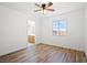 Bright bedroom featuring a ceiling fan, wood-look flooring, and an ensuite bathroom at 5628 Crimson Ridge Dr, Las Vegas, NV 89130