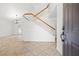 Bright entryway featuring tile floors, a staircase with wood banisters, and an open floorplan at 5628 Crimson Ridge Dr, Las Vegas, NV 89130