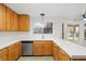 Bright kitchen equipped with oak cabinets, stainless steel dishwasher, and bright countertops at 5628 Crimson Ridge Dr, Las Vegas, NV 89130