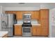 Updated kitchen showcasing stainless steel appliances, oak cabinetry, and white countertops at 5628 Crimson Ridge Dr, Las Vegas, NV 89130