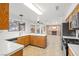 Modern kitchen featuring white countertops, wood cabinets, stainless steel appliances, and an open floor plan at 5628 Crimson Ridge Dr, Las Vegas, NV 89130