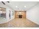 Open living room featuring a stone fireplace, tile floors, and natural light at 5628 Crimson Ridge Dr, Las Vegas, NV 89130