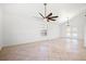 Open living room featuring tile flooring, modern fan, and large glass patio doors with natural light at 5628 Crimson Ridge Dr, Las Vegas, NV 89130
