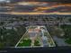 Aerial shot of the estate with a pool, large lawn and impressive outbuildings at 5700 N Torrey Pines Dr, Las Vegas, NV 89130