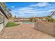 Landscaped backyard featuring a sparkling pool, pergola, and brick patio at 5700 N Torrey Pines Dr, Las Vegas, NV 89130