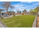Expansive backyard featuring a vast lawn, ample space, mature trees, and covered parking area at 5700 N Torrey Pines Dr, Las Vegas, NV 89130
