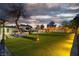 Expansive backyard with lush lawn, pergola, and mature trees, ideal for outdoor activities at 5700 N Torrey Pines Dr, Las Vegas, NV 89130