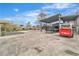 Wide concrete backyard showcasing covered parking and ample space for vehicles and other machinery at 5700 N Torrey Pines Dr, Las Vegas, NV 89130