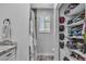 Bright bathroom showcasing a modern vanity and well-organized closet with shelving at 5700 N Torrey Pines Dr, Las Vegas, NV 89130