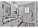 Bathroom featuring double sinks with granite countertops and modern fixtures at 5700 N Torrey Pines Dr, Las Vegas, NV 89130