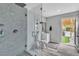 Bathroom with walk-in shower and backyard access to outdoor seating area at 5700 N Torrey Pines Dr, Las Vegas, NV 89130