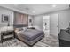 Cozy bedroom with wood-look floors, a comfortable bed, and natural lighting at 5700 N Torrey Pines Dr, Las Vegas, NV 89130