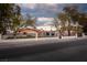 Charming home with black trim, arched entryways, and lush landscaping at 5700 N Torrey Pines Dr, Las Vegas, NV 89130
