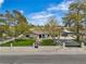 Charming single-story home with lush green lawn and mature trees on a sunny day at 5700 N Torrey Pines Dr, Las Vegas, NV 89130