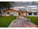 Front exterior of charming home with brick walkway and manicured lawn at 5700 N Torrey Pines Dr, Las Vegas, NV 89130