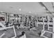Extensive home gym with state-of-the-art weightlifting equipment, mirrored walls, and ample workout space at 5700 N Torrey Pines Dr, Las Vegas, NV 89130