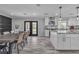 Open concept dining room and kitchen with an island, granite counters, and stainless steel appliances at 5700 N Torrey Pines Dr, Las Vegas, NV 89130