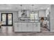 Bright kitchen with white cabinets, granite countertops, stainless steel appliances, and pendant lighting over the island at 5700 N Torrey Pines Dr, Las Vegas, NV 89130