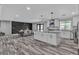 Open concept floor plan of a bright kitchen with large island, granite counters, and breakfast nook at 5700 N Torrey Pines Dr, Las Vegas, NV 89130
