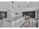 Bright kitchen featuring a large island with granite countertops and an open view of the dining area at 5700 N Torrey Pines Dr, Las Vegas, NV 89130