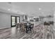 Open-concept living room and dining area featuring modern finishes and access to the pool at 5700 N Torrey Pines Dr, Las Vegas, NV 89130