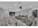 Open concept living room featuring stylish decor, a large sofa, and modern flooring throughout the home at 5700 N Torrey Pines Dr, Las Vegas, NV 89130