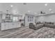 Open-concept living area with stylish flooring, a modern kitchen, and comfortable seating at 5700 N Torrey Pines Dr, Las Vegas, NV 89130