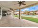 Covered patio with ceiling fans overlooking outdoor kitchen, pool and pergola at 5700 N Torrey Pines Dr, Las Vegas, NV 89130
