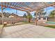 Backyard with a large pergola, outdoor seating, and a swing set near the pool at 5700 N Torrey Pines Dr, Las Vegas, NV 89130