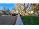 Exterior shot showcasing the community's green space with mature trees and walkways at 5710 E Tropicana Ave # 2049, Las Vegas, NV 89122