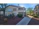 Attractive condominium featuring well-maintained landscaping and a welcoming walkway leading to the entrance at 5710 E Tropicana Ave # 2049, Las Vegas, NV 89122
