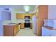 Functional kitchen with ample cabinet space, white countertops, and essential appliances at 5710 E Tropicana Ave # 2049, Las Vegas, NV 89122